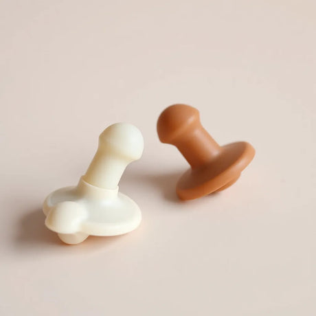 Two silicone adult nipple suckers with suction cups on a clean neutral background