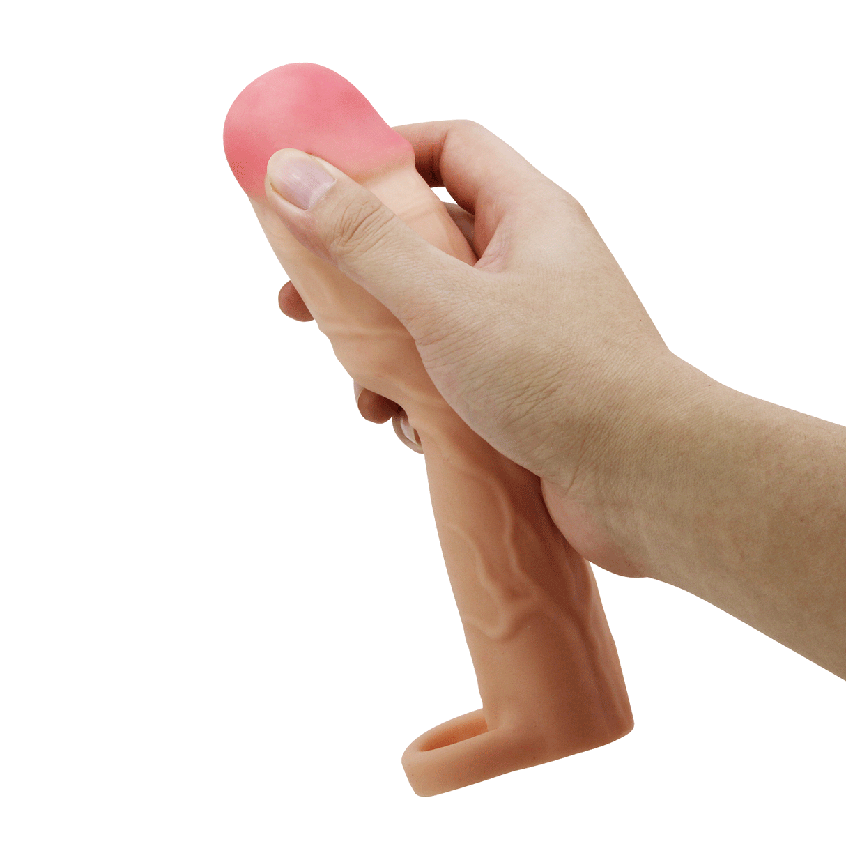 A hand holds a flesh-toned TPR penis extender sleeve with a pink tip and textured veins.